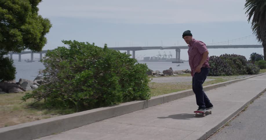 A skateboarder rides next to the road