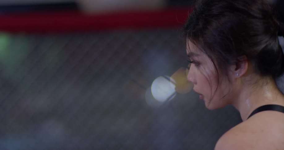 A woman trains inside an mma gym