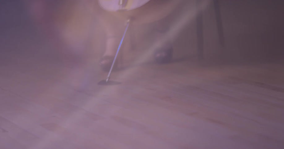 A woman holds a cello in place as she sits