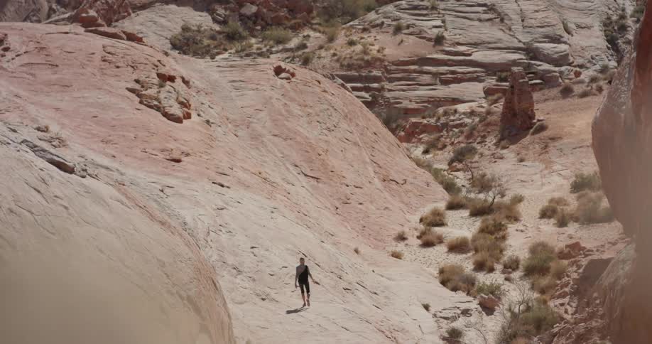 A person is hiking in the rocks below