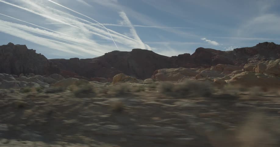 Sun shines over rocky hilly desert land