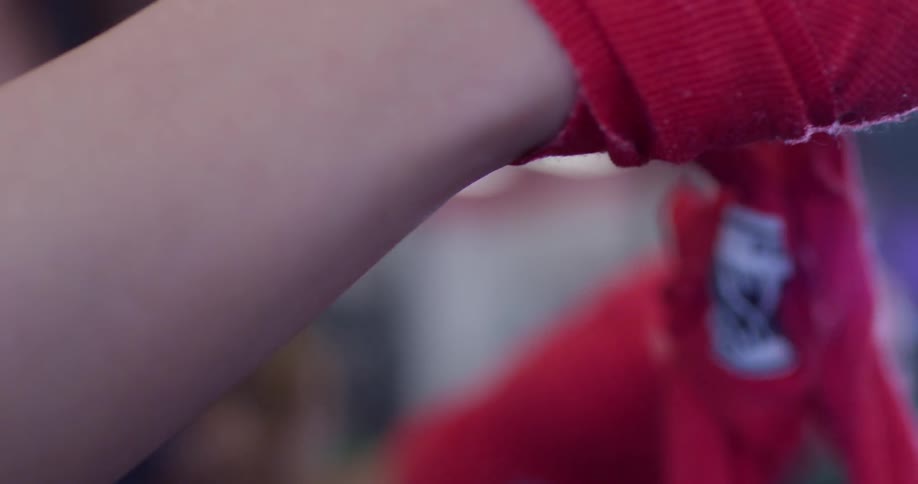 A woman untangles athletic tape in a gym