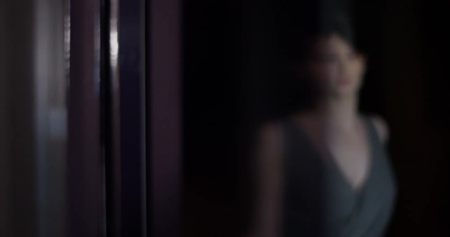 A woman walks in a hallway