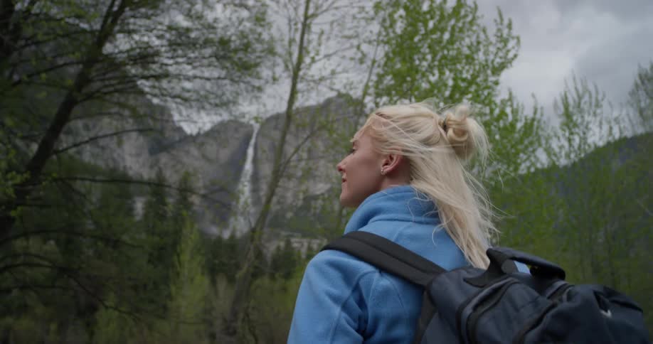 A woman hikes in a mountain forest