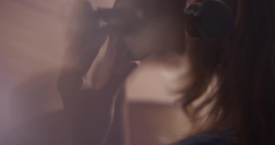 Person plays the cello in a brightly lit room