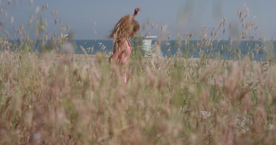 A woman stretches outside near the beach