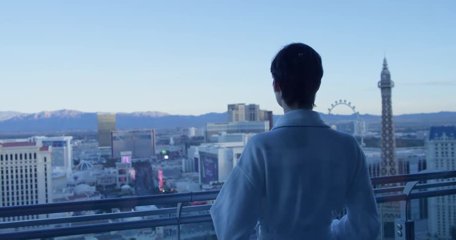 A woman stands on a hotel balcony in las vegas