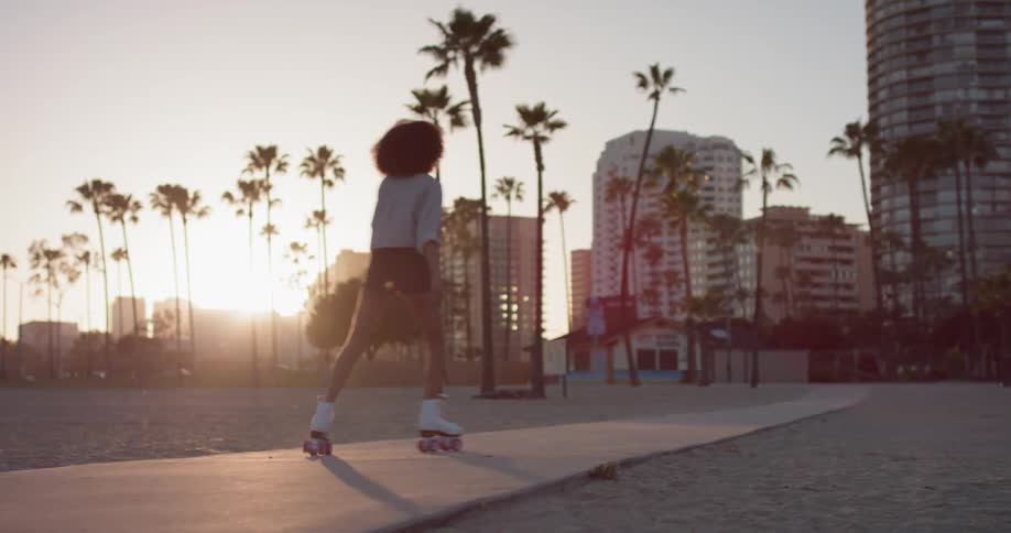 Woman Rollerblading Around Beach