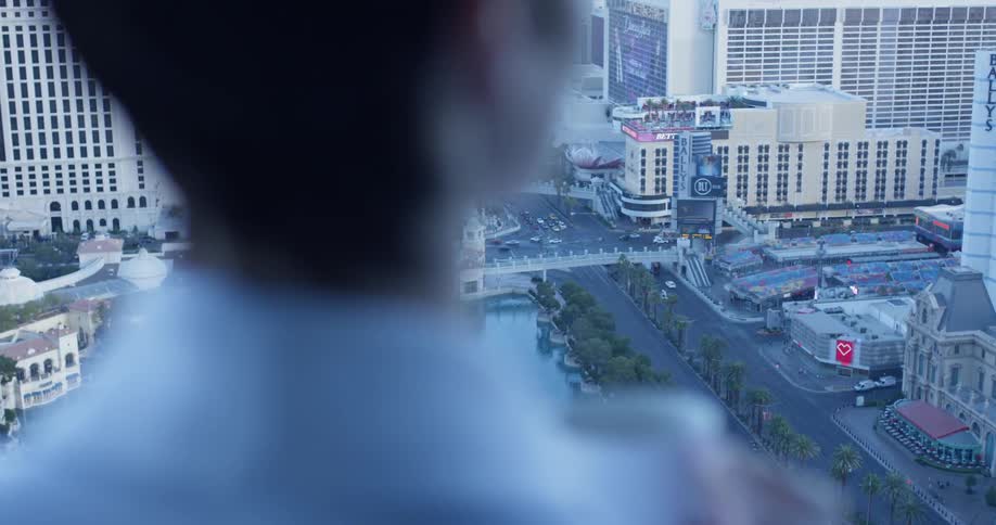 A woman drinks coffee on a hotel balcony in las vegas