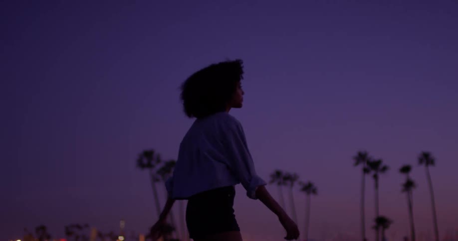 Woman roller skates in the city at night