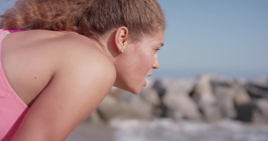 A woman leans over to catch her breath