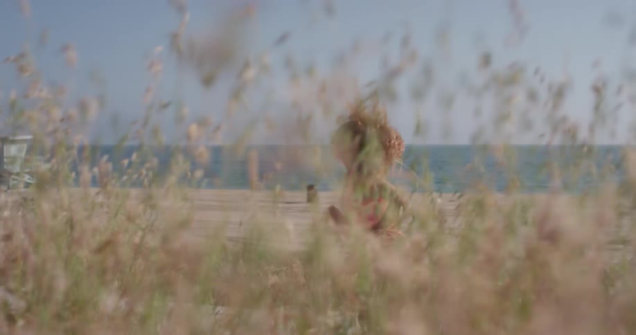 A woman exercises on a beach
