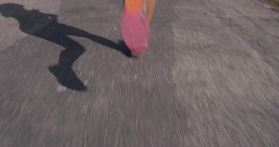 A woman runs fast on the gravel