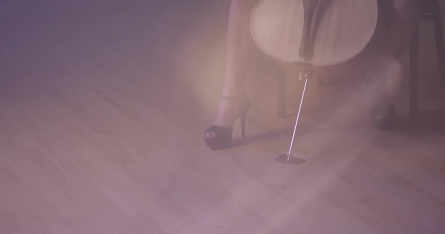 A woman is playing a cello inside in daylight