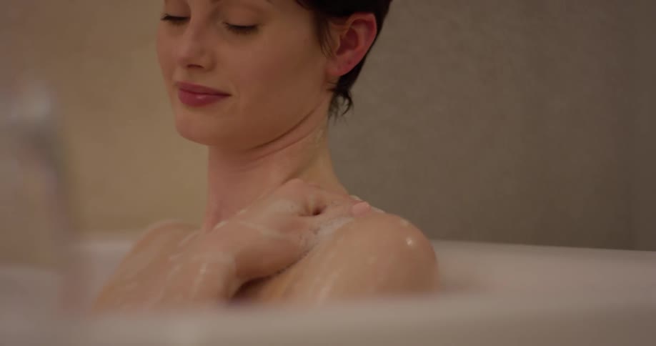 A woman relaxes in a bubble bath