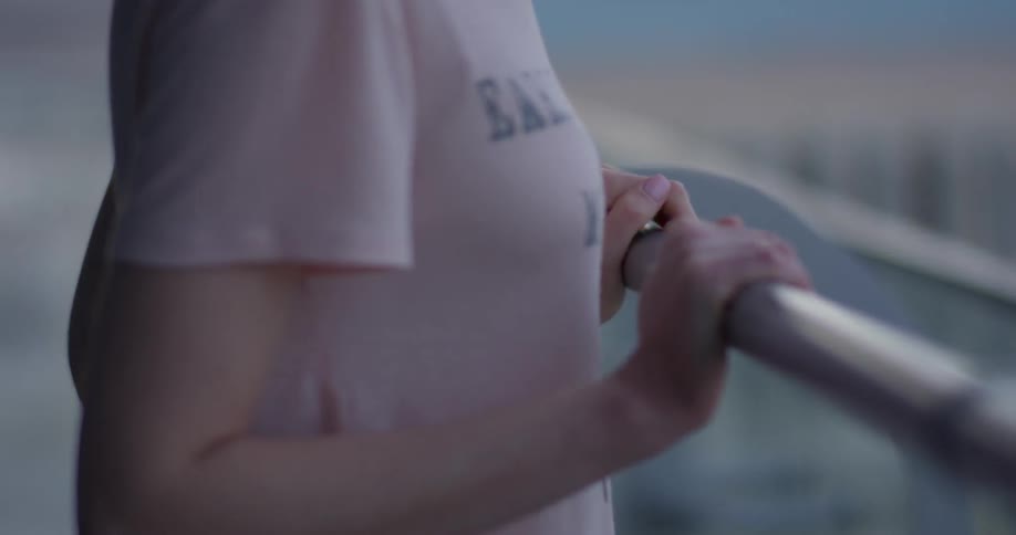 A woman leans against the railing