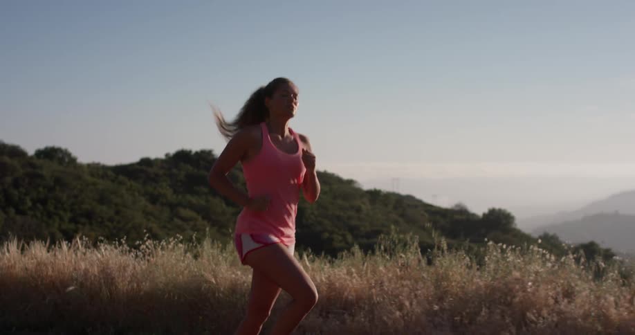 Woman stretches her arms and starts jogging outside