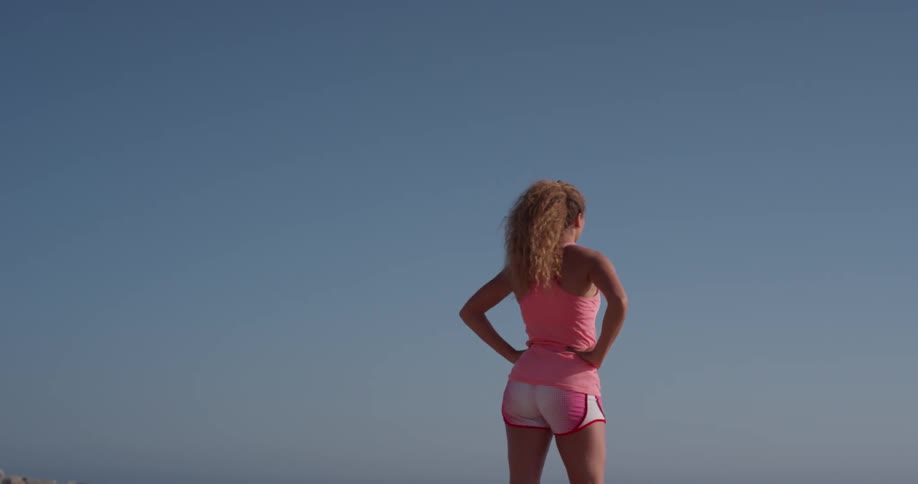 A woman stretches on a beach