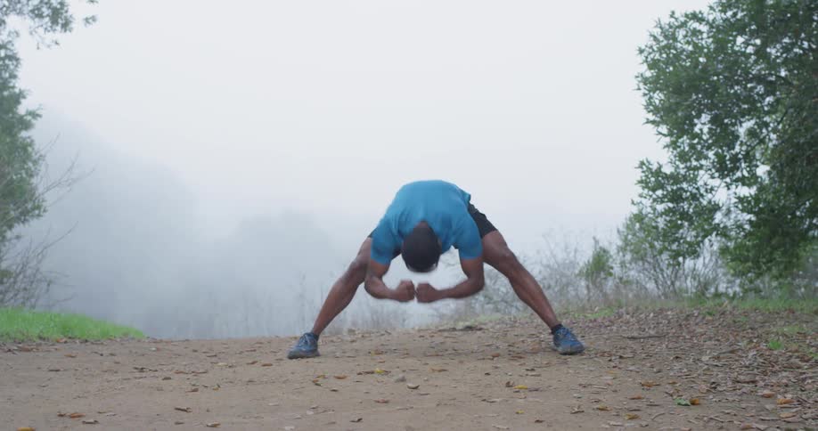 A man stretches leaning forward