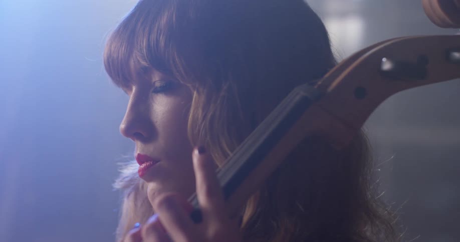A woman is playing the instrument fast then slow