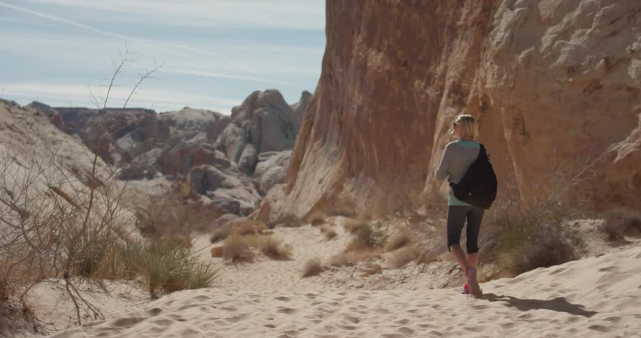 A woman hikes in a desert