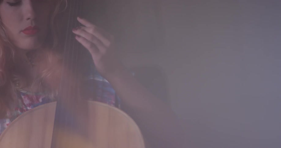 Woman plays the cello in a brightly lit room