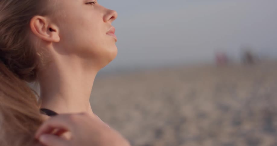 Woman with long hair stretches her neck