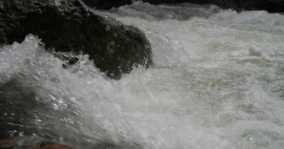 Water splashes over the rocks in the creek