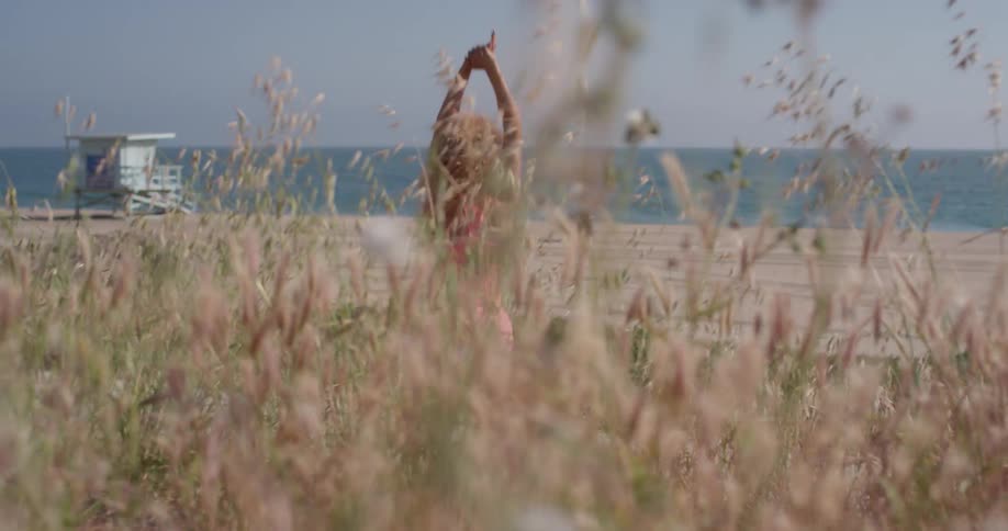 A woman jogs in place near the beach