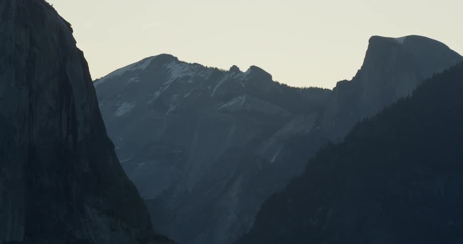 Sun sets over rocky mountains