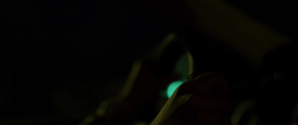 A person drives their car at night