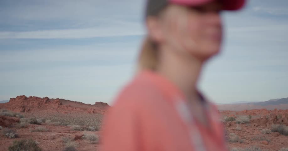A woman hikes alone in a desert