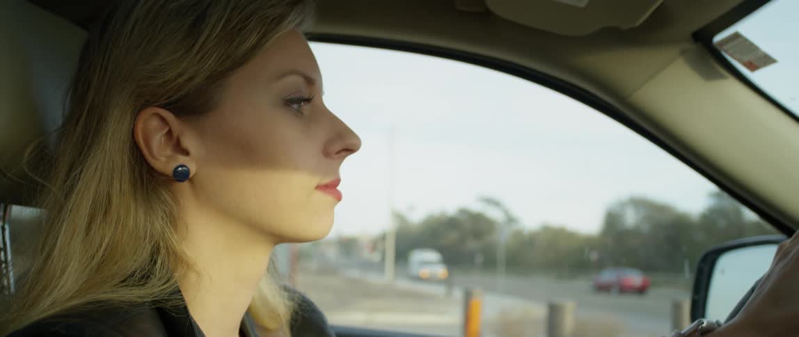 Woman drives a vehicle on a city road