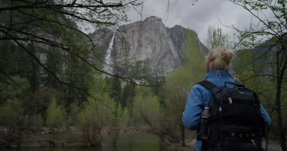 A woman hikes in a mountain forest