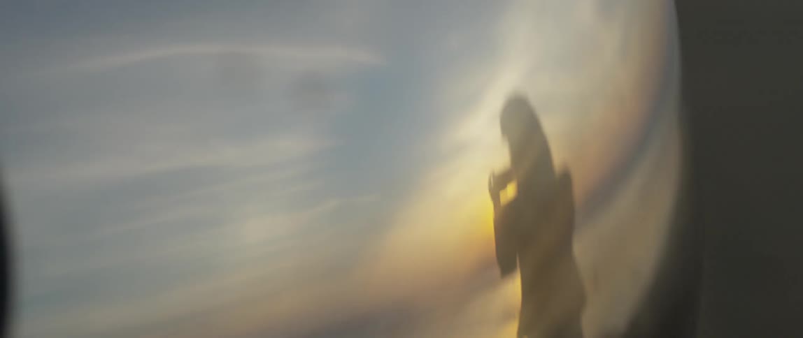 Shadow of a person taking a picture at sunset