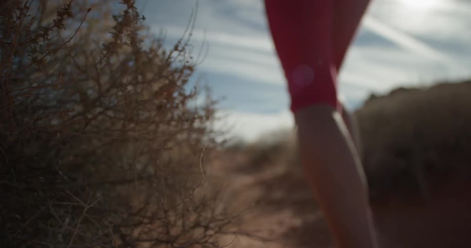 A woman jogs in a desert