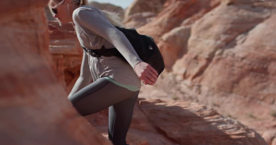 A woman hikes alone in a desert