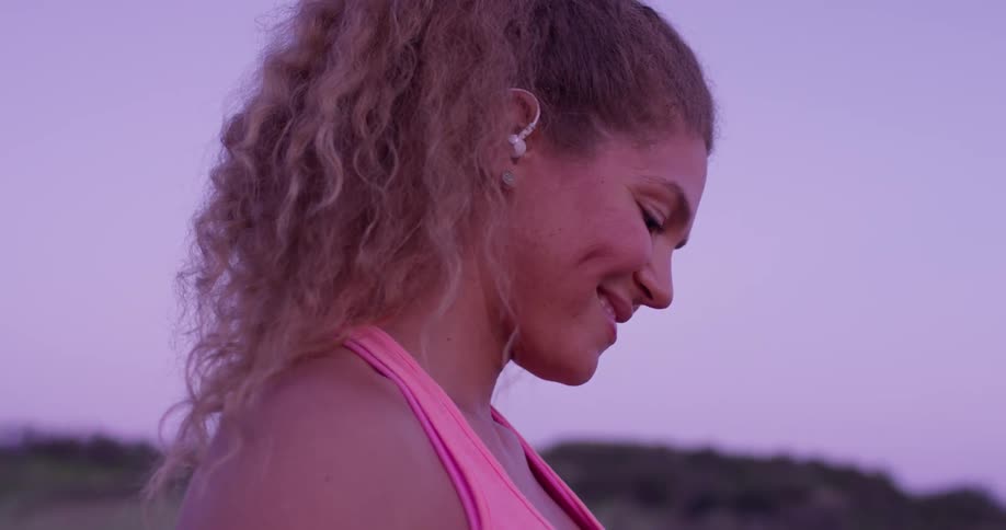 A woman jogs outside at sunset