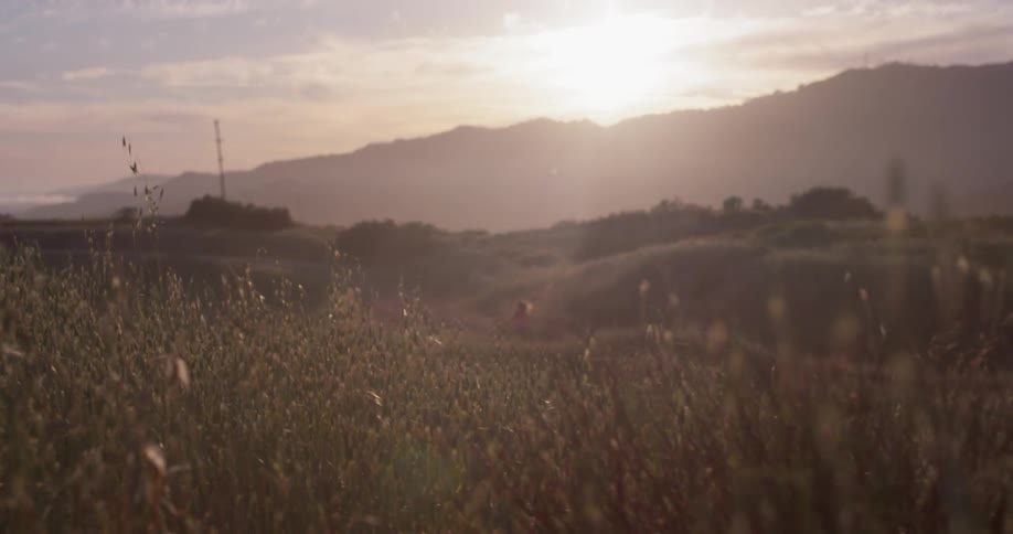 The sun is nearly set behind the mountains