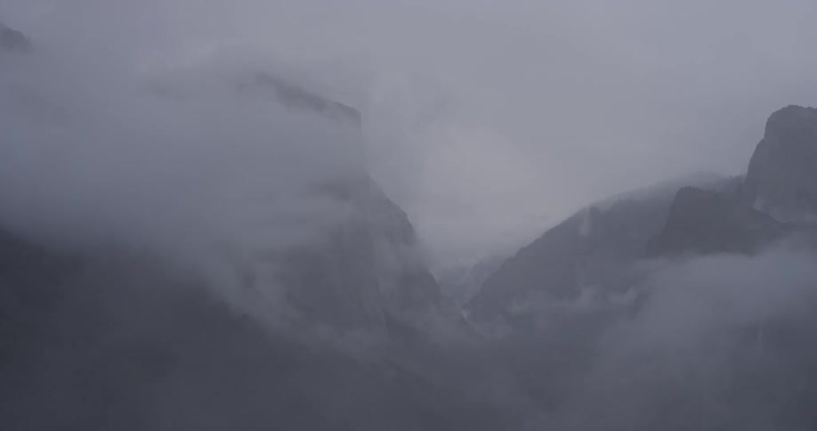 The mountains are covered in thick fog