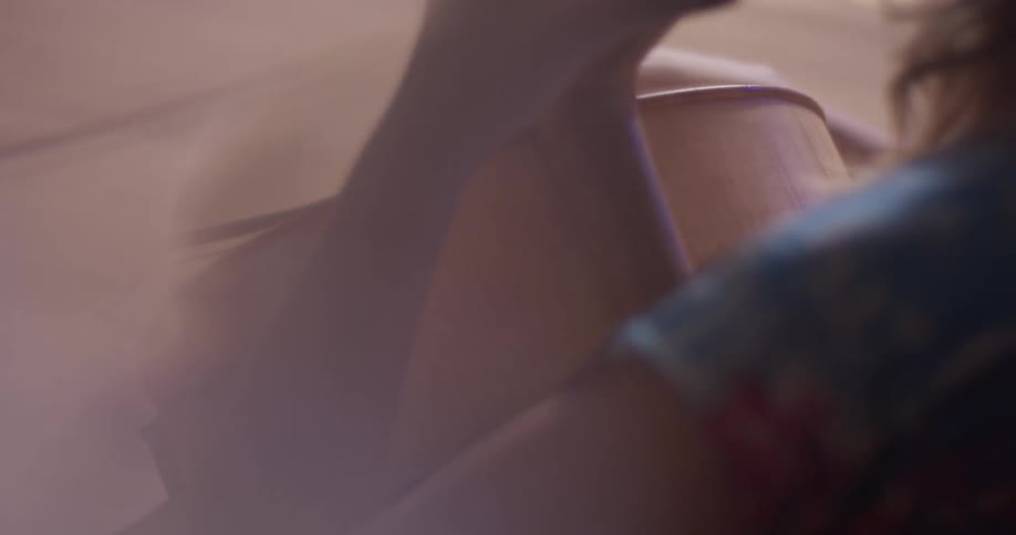A woman is holding the instrument and playing