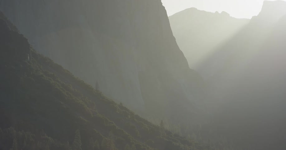 Sunlight shines in tall mountains