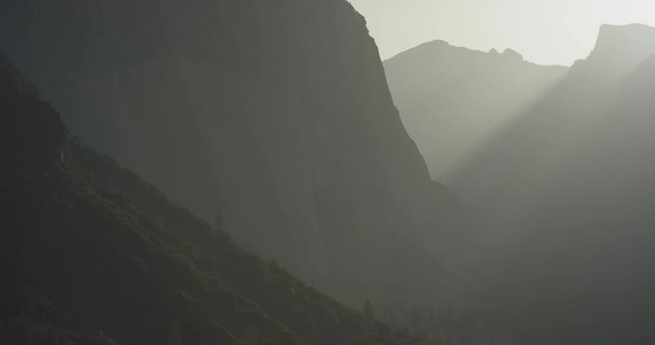 Sunlight shines over tall mountains