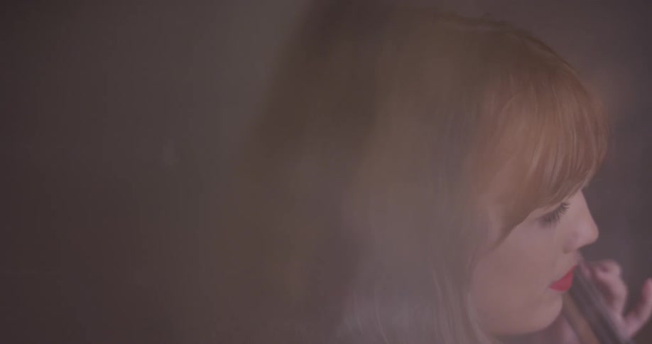 Woman plays cello with her eyes closed