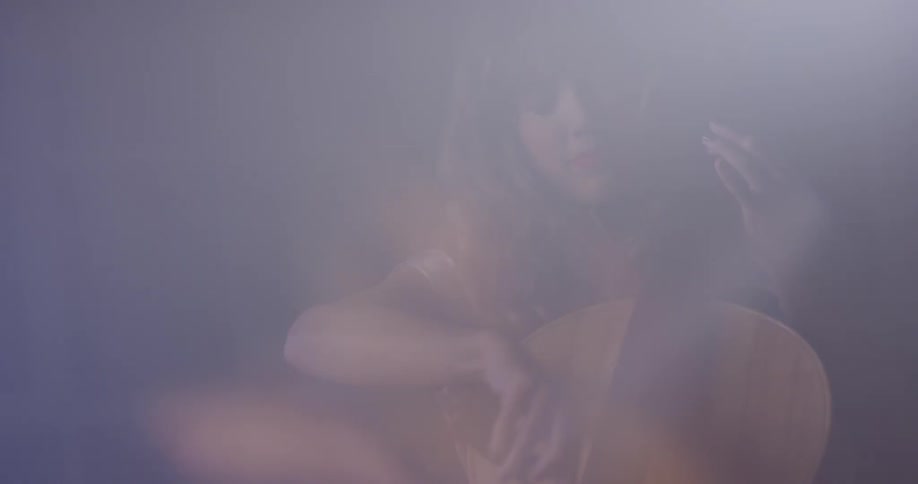 Woman plays a cello in blurry light