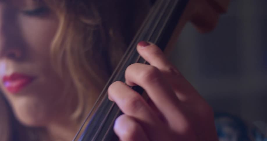 Woman plays the cello and nods her head