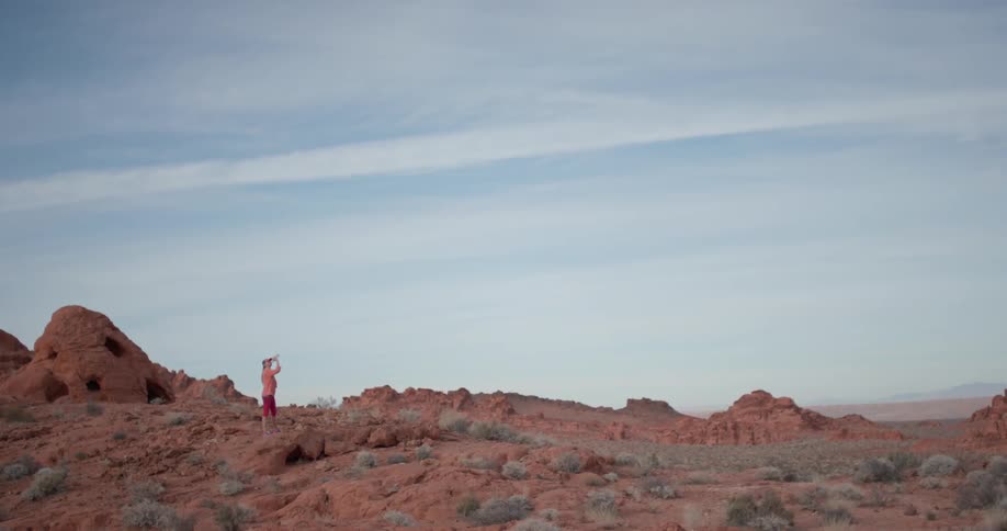 A woman hikes alone in a desert