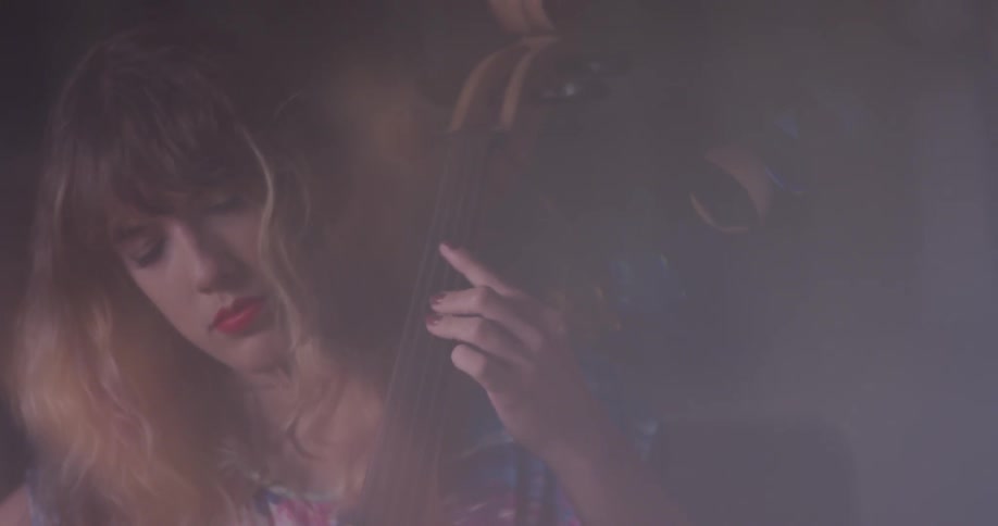 Woman is closing her eyes while playing the cello