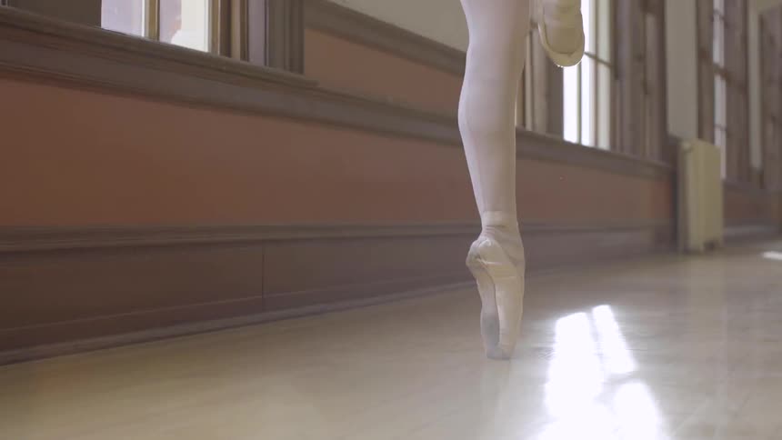 A woman is dancing in tights