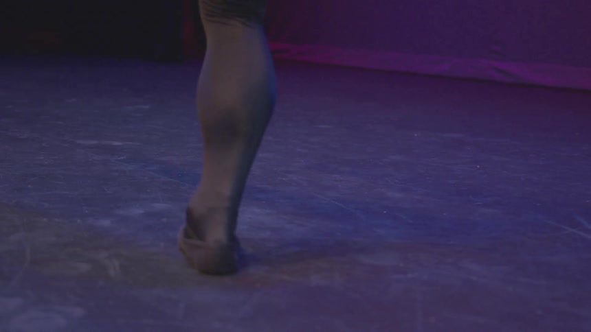 A dancer spins on one foot